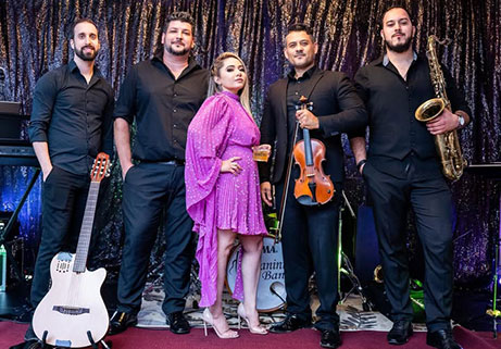 Paganini Brazilian Band posing with violin, saxophone, guitar, and band members at Locktown Stone Church.