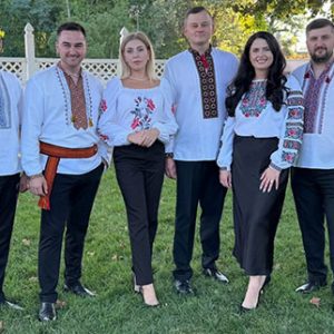 Soloway Band members standing outdoors in embroidered traditional attire before performing at Locktown Stone Church.